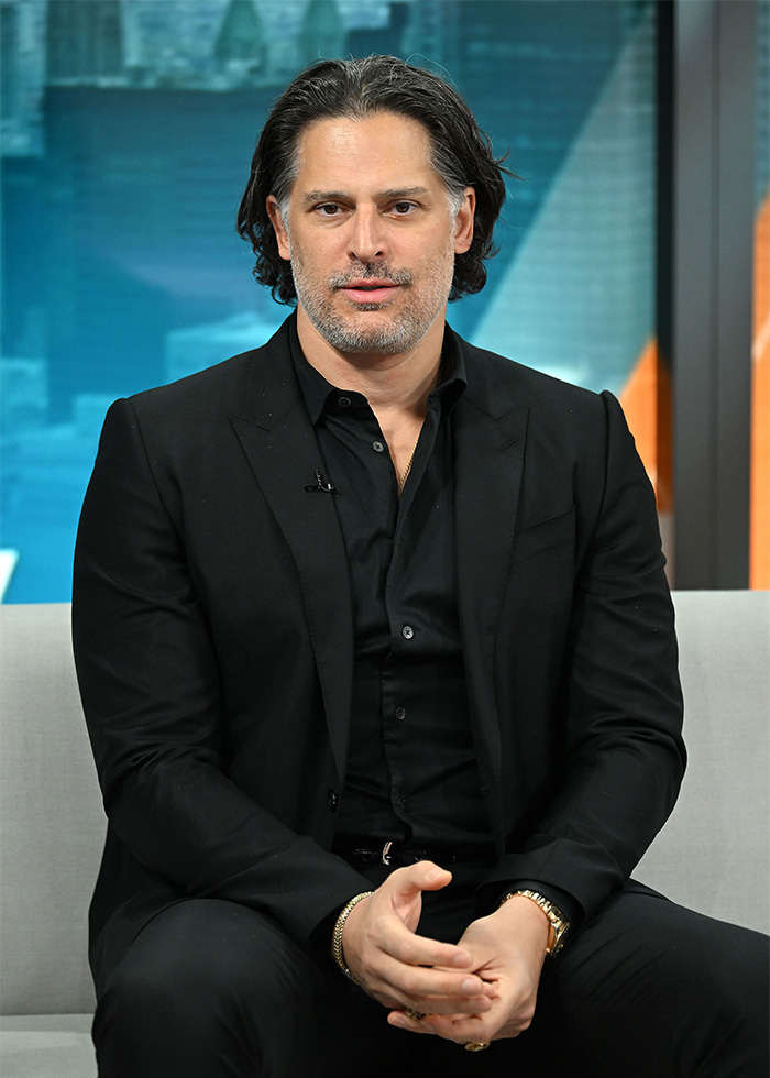 Joe Manganiello sitting, looking at the camera, revealing the brutal side effects of his mystery illness.