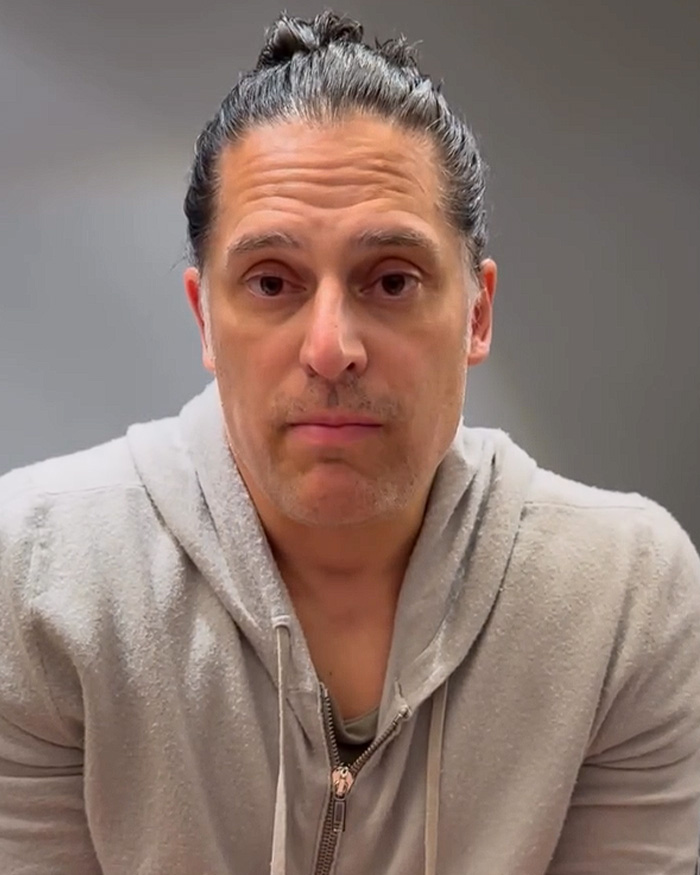 Joe Manganiello looks serious in a grey hoodie, discussing his mystery illness and brutal side effects.