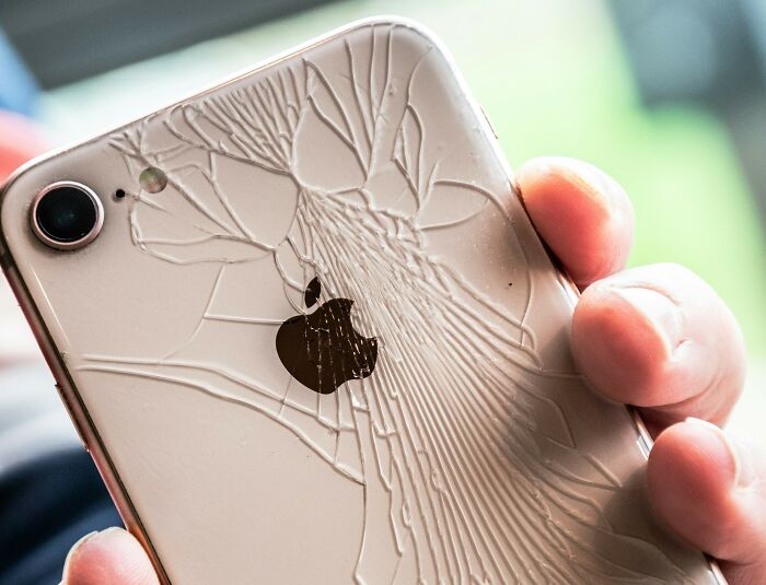 Close-up of iPhone with shattered back glass