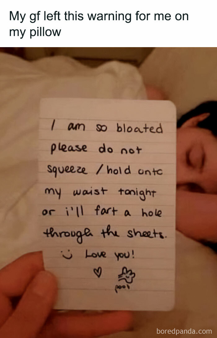 A hand holding a note on a pillow with a warning about blursed memes to make you laugh.