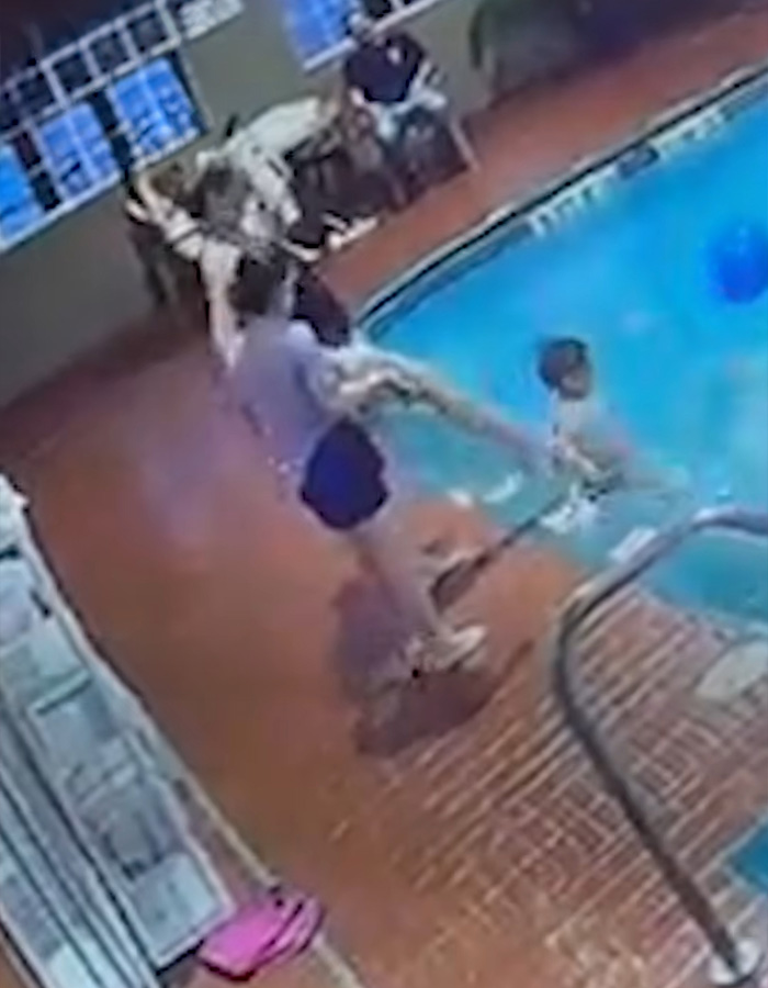Moment a woman kicks a child into a hotel swimming pool captured by security camera