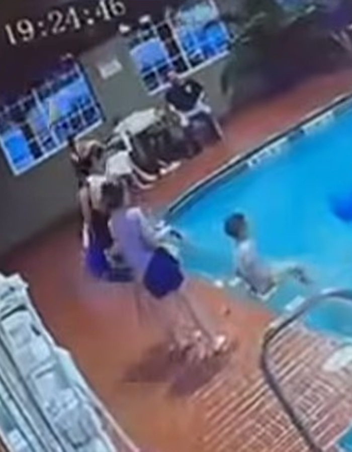 Surveillance footage showing a woman kicking a child into a hotel swimming pool