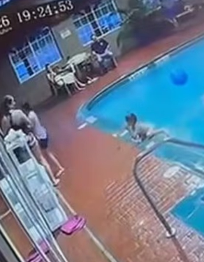 CCTV image of a child swimming in a hotel pool after being kicked in
