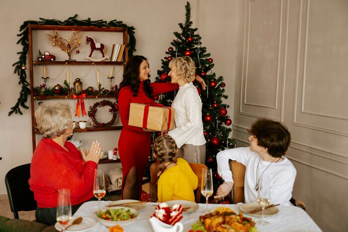 Family exchanging gifts at Christmas for healing after relationship betrayal
