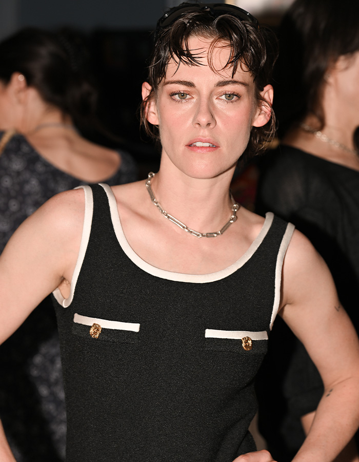 Kristen Stewart's interaction, in a black and white top. Fans call out invading personal space.