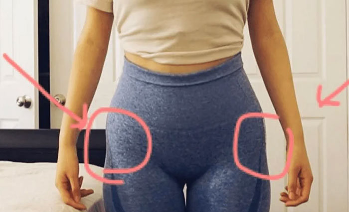 Close-up of woman wearing blue leggings with circles drawn on hips