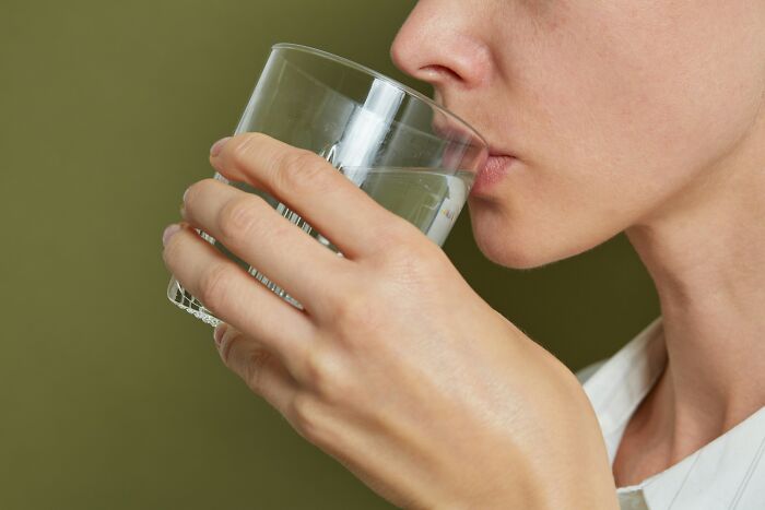 Person drinking clean water symbolizing American luxury