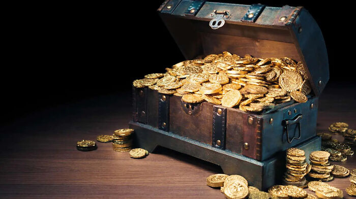 An open wooden lost treasures chest overflowing with gold coins, symbolizing immense wealth and historical value.