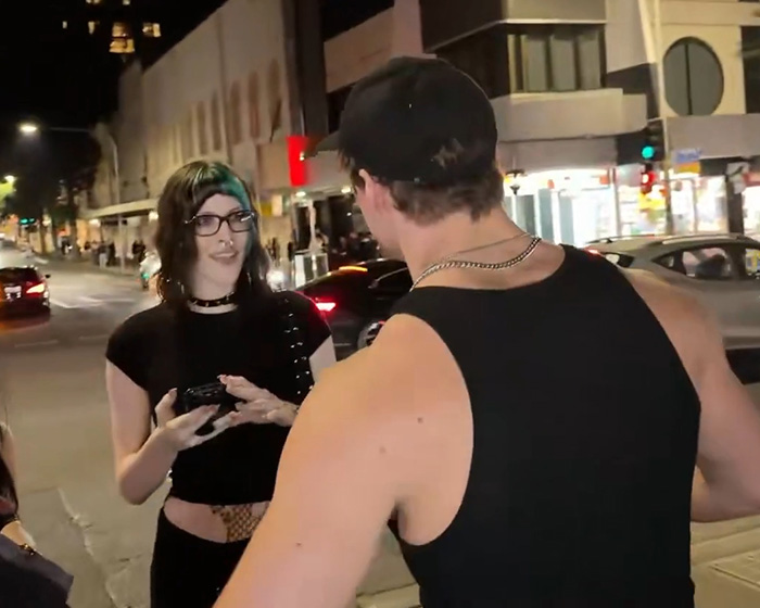 Looksmaxxer Androgenic interacts with a trans woman on a city street at night, looking surprised. Looksmaxxer Androgenic interacts with a trans woman on a city street at night, looking surprised.