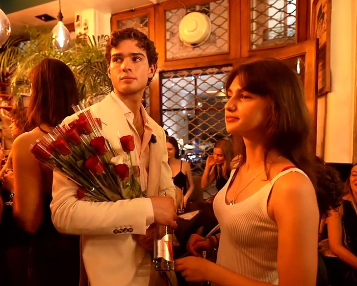 Looksmaxxer Clavicular holds a bouquet of roses and a drink, looking at a woman who rejected him in Paris. Looksmaxxer Clavicular holds a bouquet of roses and a drink, looking at a woman who rejected him in Paris.