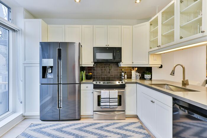Modern kitchen with stainless steel appliances and white cabinets