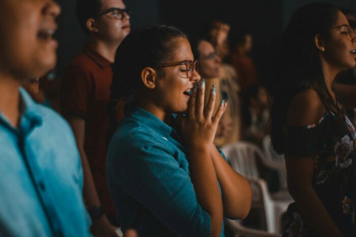 Group of people praying or reacting emotionally during a mass walkouts event