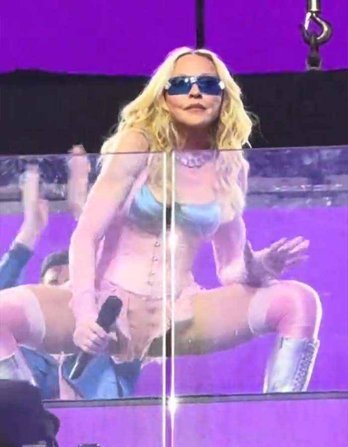 Madonna's performance in Times Square, wearing sunglasses and a corset, sparks hilarious reactions.