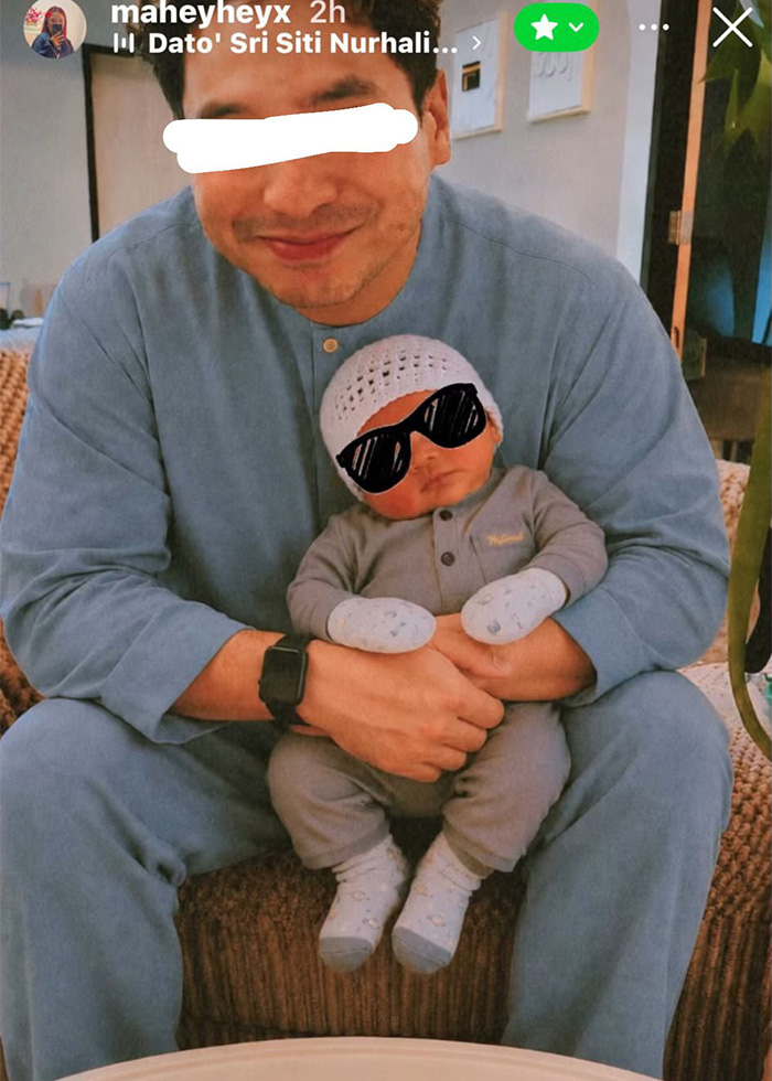 A man holds a baby, while fake photos were used to pretend they have a family, causing trauma. A man holds a baby, while fake photos were used to pretend they have a family, causing trauma.