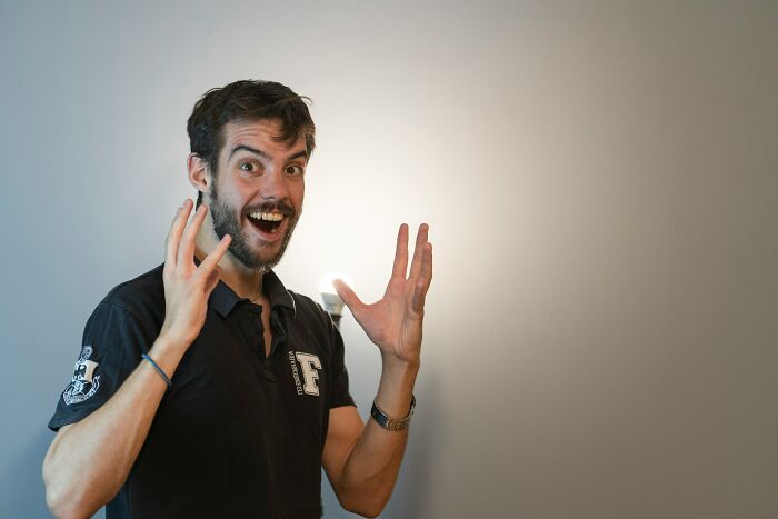 Surprised man making expressive gestures with hands