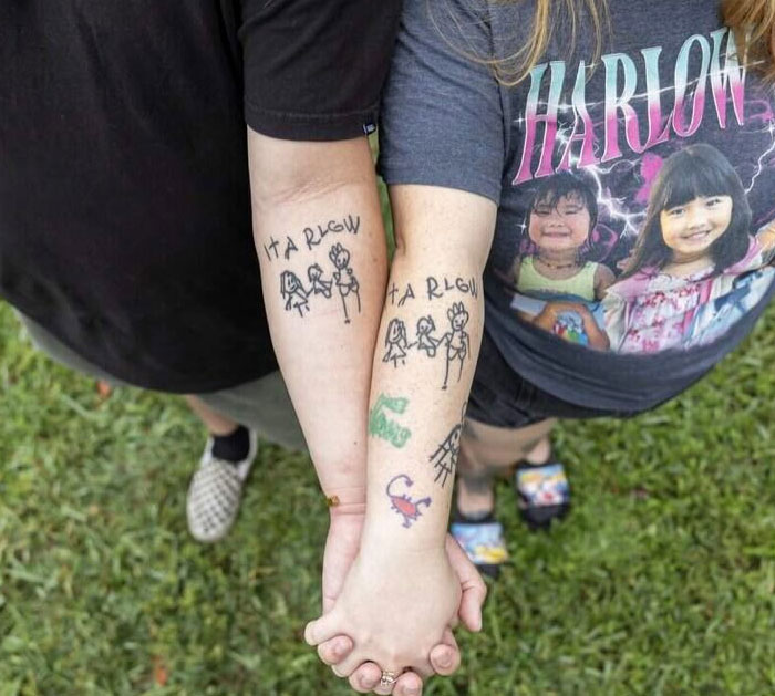 Two arms with matching Harlow tattoos of a family, holding hands, symbolizing tattoos that mean more.