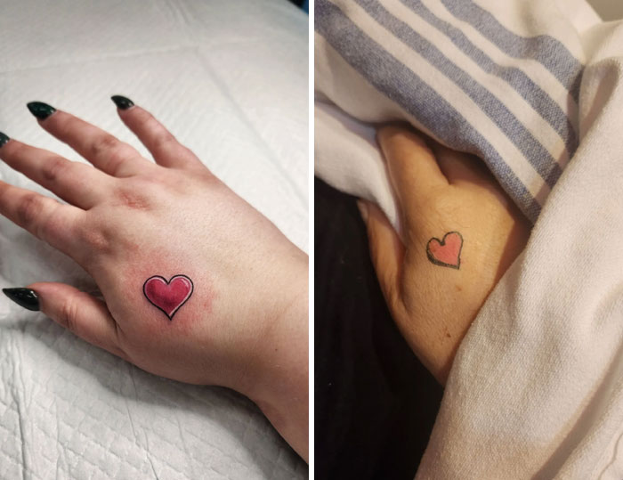 Matching heart tattoos on hands, symbolizing a deep bond and meaningful connection.