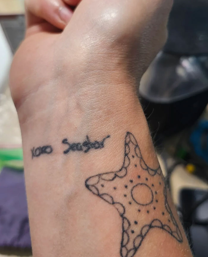 A close-up of a wrist with two tattoos: xoxo Sister written in script and an outline of a starfish. This tattoo has significant meaning.