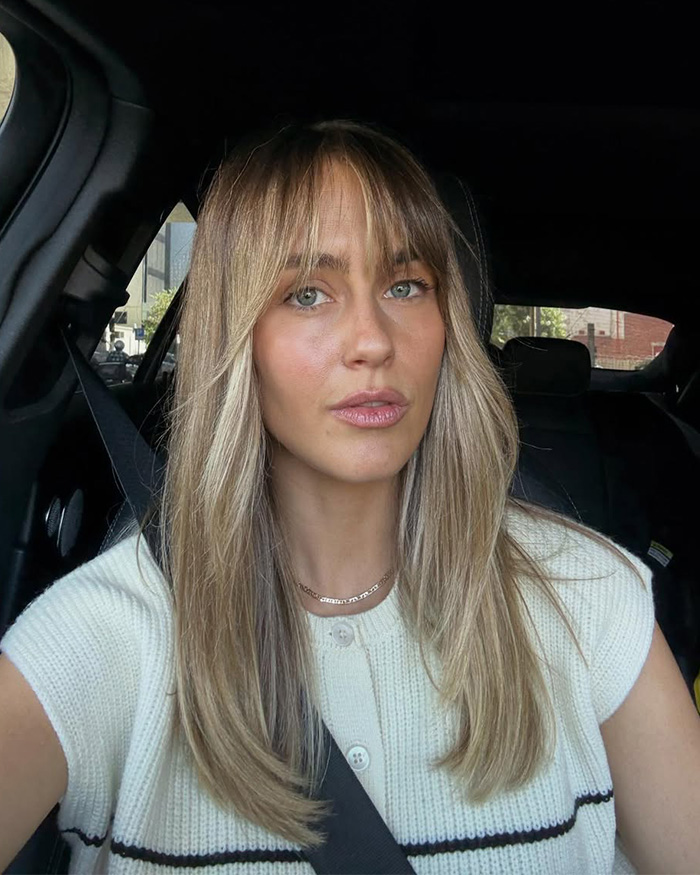 Media personality in a car, looking at the camera, discussing bedroom confession.