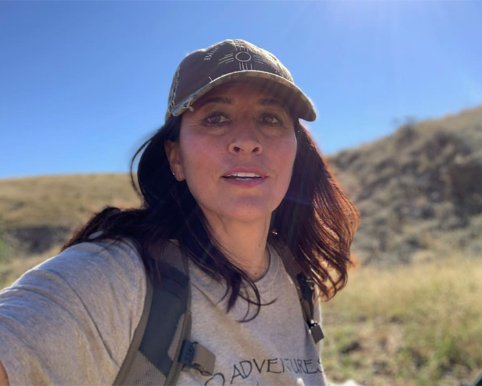 Missing scientist woman outdoors wearing adventure gear and cap Missing scientist woman outdoors wearing adventure gear and cap