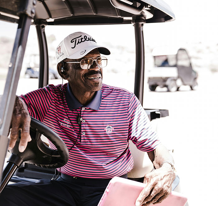 Man in golf cart wearing cap smiling relaxed moment free therapists
