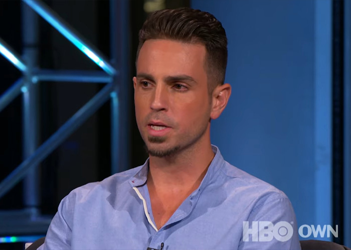 Man speaking in a studio interview with HBO OWN logo visible
