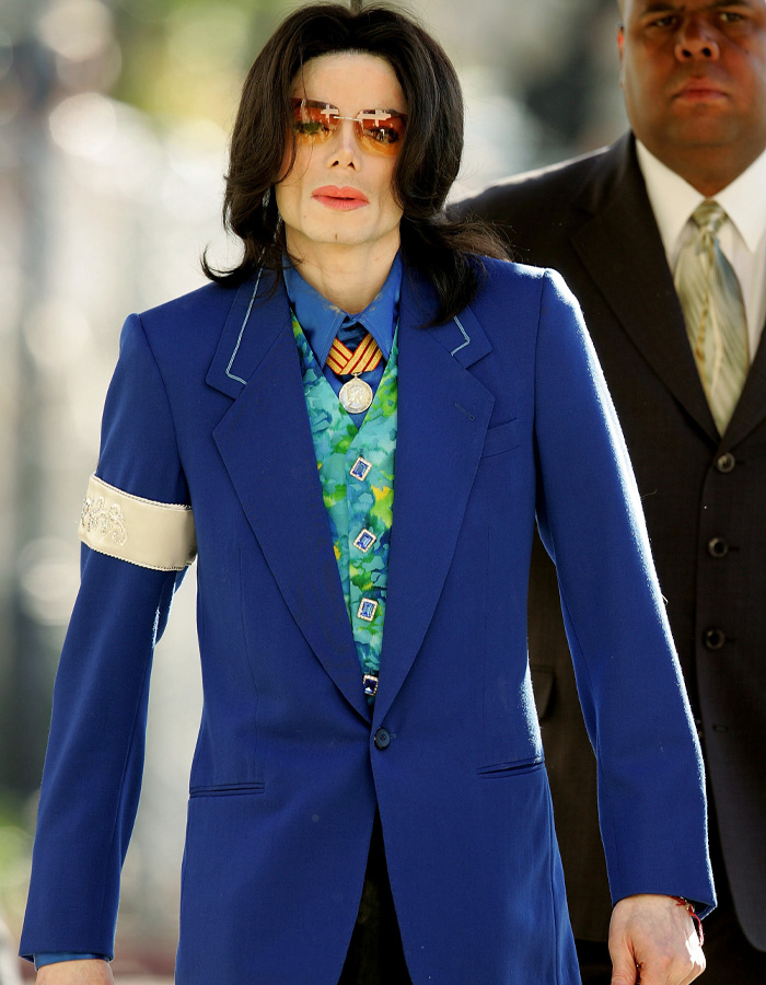 Michael Jackson in colorful blue suit and tinted glasses outdoors