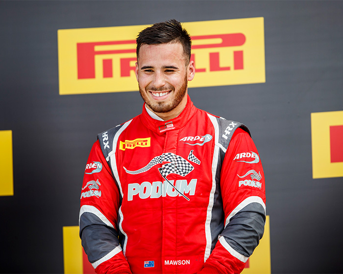 Young race car driver smiling in red racing suit with Pirelli logos Young race car driver smiling in red racing suit with Pirelli logos