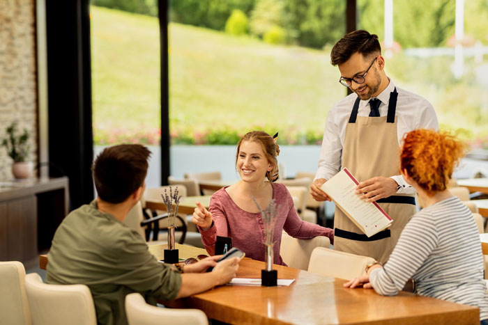 Family at a restaurant for Mother's Day, with a waiter taking orders, showing a special Mother's Day celebration. Family at a restaurant for Mother's Day, with a waiter taking orders, showing a special Mother's Day celebration.