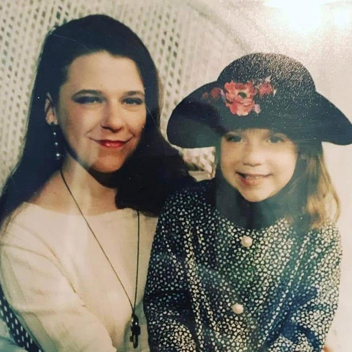 A smiling mom with long dark hair next to a young girl in a wide-brimmed hat, from the FBI unravels disturbing details case.