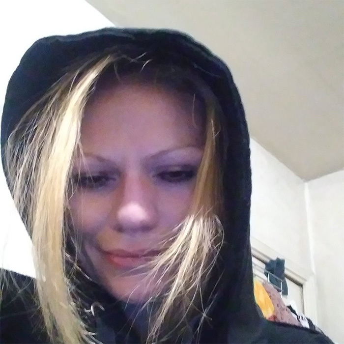 A woman with blonde hair wearing a black hoodie, part of a story about a mom and a house of horrors with disturbing details.