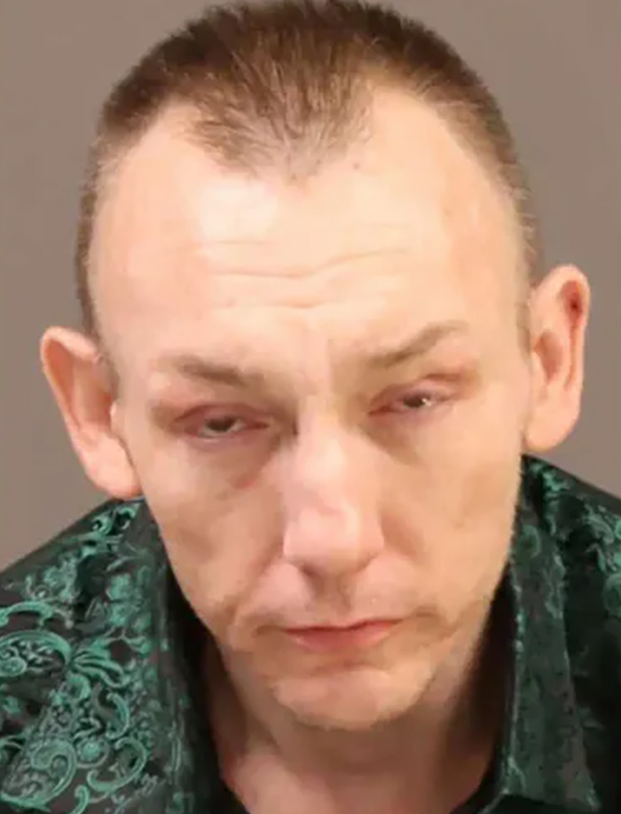 Mugshot of a man with short hair and a green patterned shirt, involved in the FBI unravels disturbing details case.