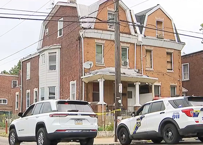 A brick house of horrors with police vehicles outside, investigating disturbing details.