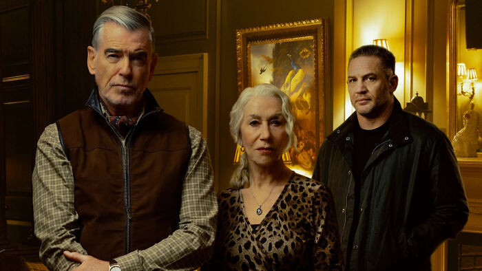 Cast of MobLand standing in a dimly lit room with vintage decor