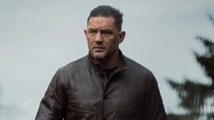 Tom Hardy wearing a dark leather jacket in an outdoor setting starring in MobLand
