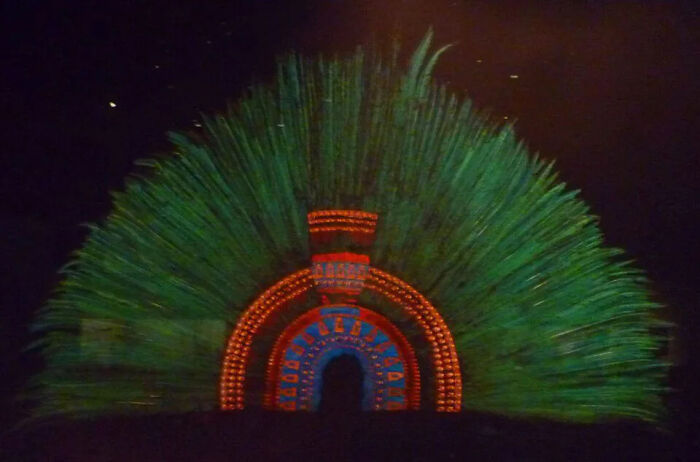 A vibrant, feathered ceremonial headdress, an example of ancient lost treasures worth billions, uncovered by researchers.