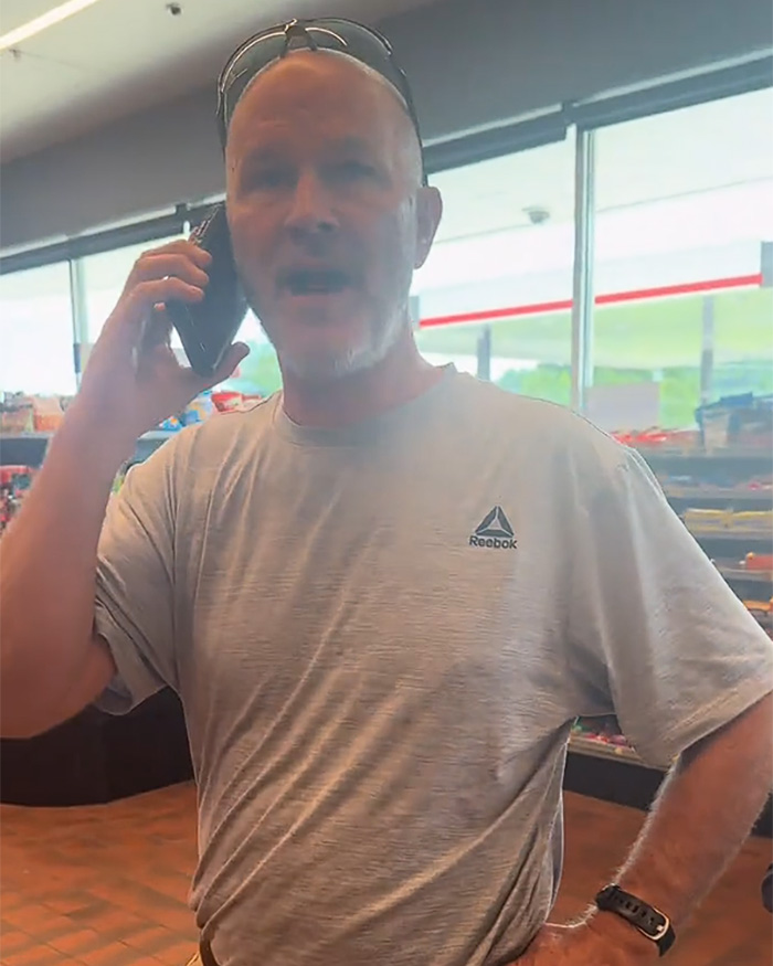 A 'Male Karen' talks on his phone, looking annoyed, in a viral restroom video incident. A 'Male Karen' talks on his phone, looking annoyed, in a viral restroom video incident.