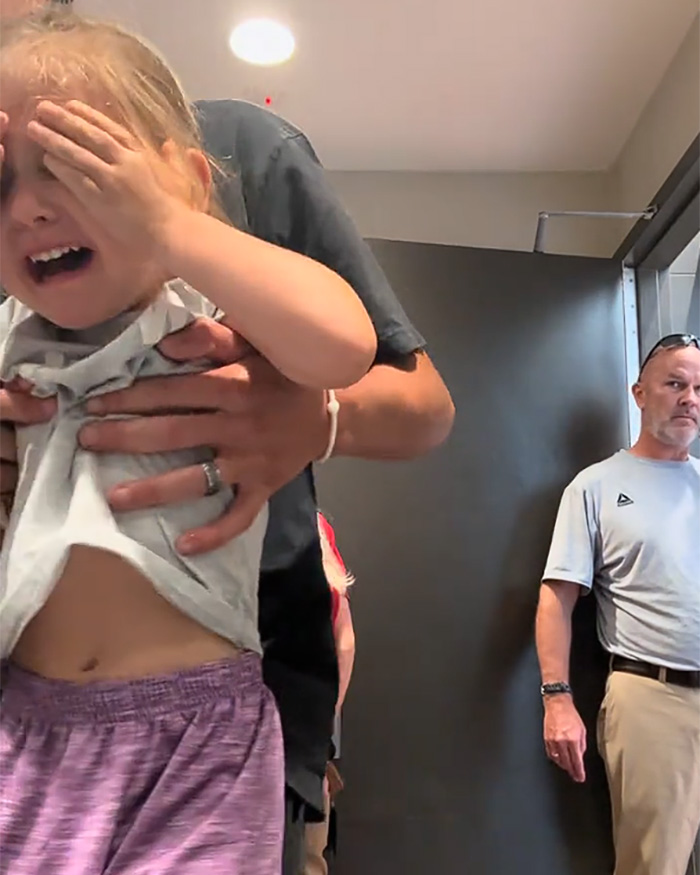 A crying girl in a restroom with a man protecting her, as a Male Karen watches in the background. A crying girl in a restroom with a man protecting her, as a Male Karen watches in the background.