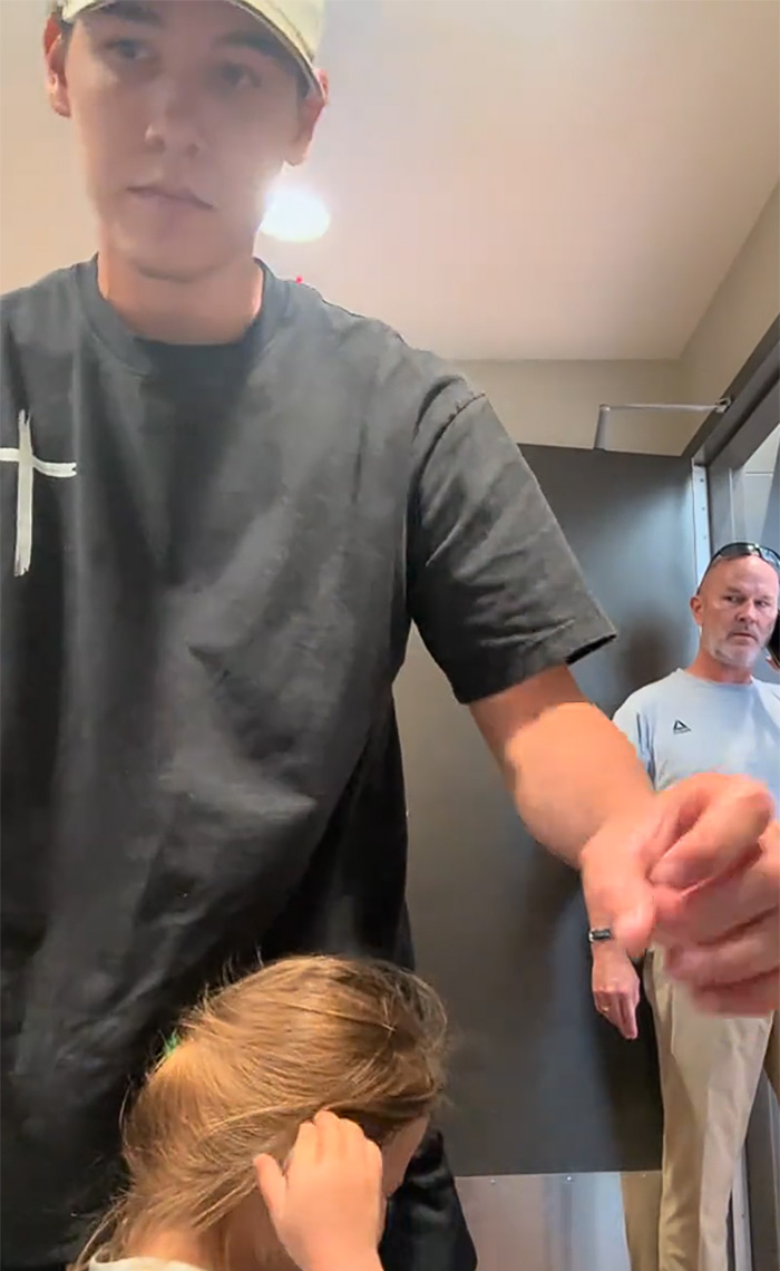 A man with a girl in a restroom, while a Male Karen stands in the background during a viral restroom video. A man with a girl in a restroom, while a Male Karen stands in the background during a viral restroom video.