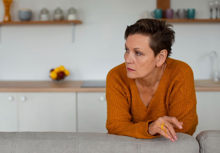 A religious mom with short hair looking concerned, reflecting on snooping in teen's room and the truth.