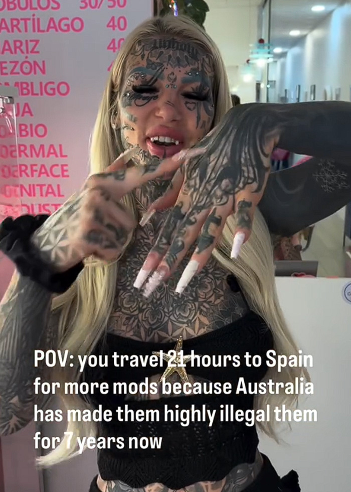 Most tattooed woman shows hand tattoos with caption about traveling for mods