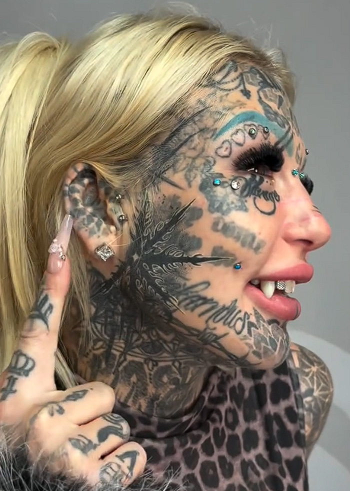 Most tattooed woman shows extensive facial tattoos and body mods with unique piercings