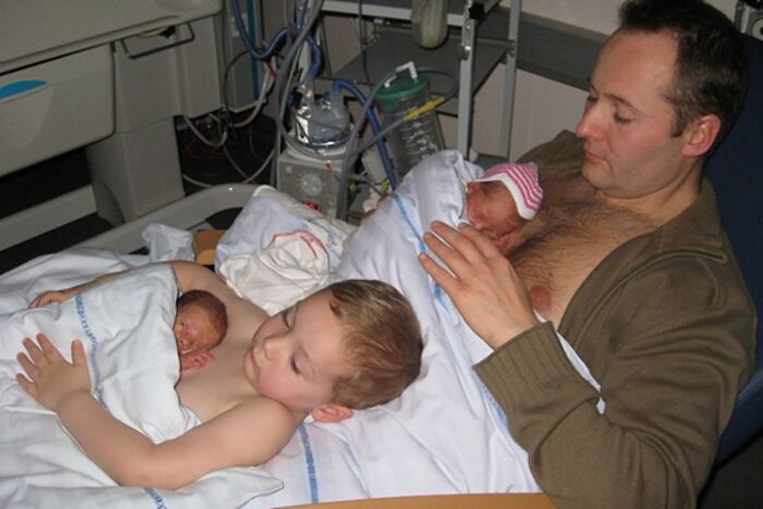 A father and his children cuddling in a hospital bed, a soul-healing scene.