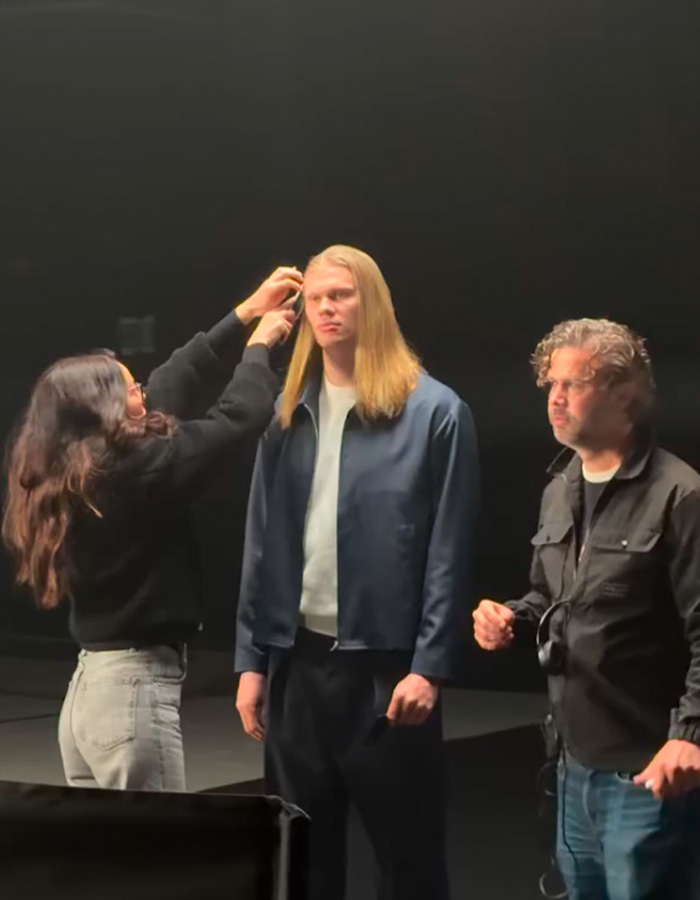 A stylist working on the Norwegian Soccer Star's long hair, hinting at his hair care secrets. A stylist working on the Norwegian Soccer Star's long hair, hinting at his hair care secrets.