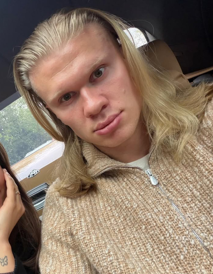 Close-up of a Norwegian soccer star with long, flowing blonde hair, highlighting his hair care secrets. Close-up of a Norwegian soccer star with long, flowing blonde hair, highlighting his hair care secrets.
