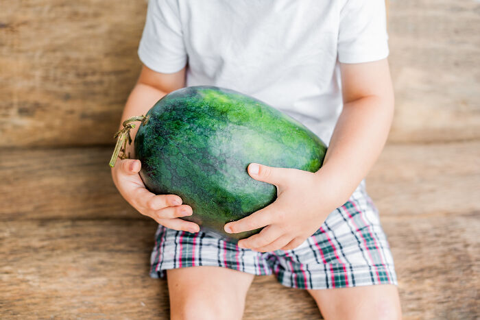 Child holding a watermelon symbolizing moments of pure generosity