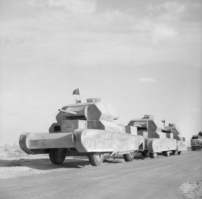 World War II decoy tanks lined up on a road in desert terrain