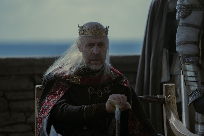 Close-up of a Targaryen king, a central figure in the House of the Dragon family tree, wearing a crown and elaborate robes. Close-up of a Targaryen king, a central figure in the House of the Dragon family tree, wearing a crown and elaborate robes.