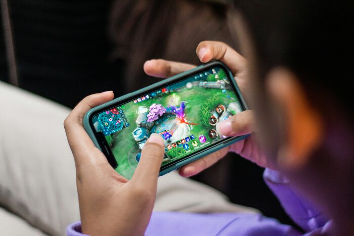 Close-up of person playing mobile game on smartphone