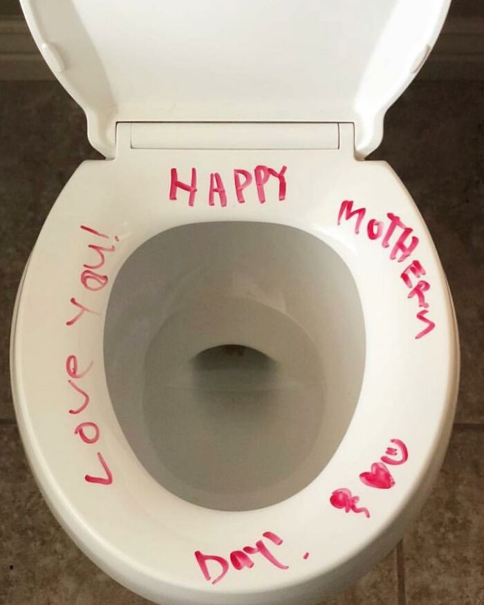 Toilet seat with happy mother day message written in red marker